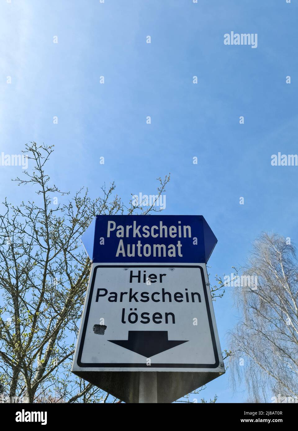 Parkschein Automat (car parking ticket machine) in front of huge mountains  in Tirol, Austria. Travelling in Europe with a car and looking for a  parking lot. The environment is beautiful. Nature Stock