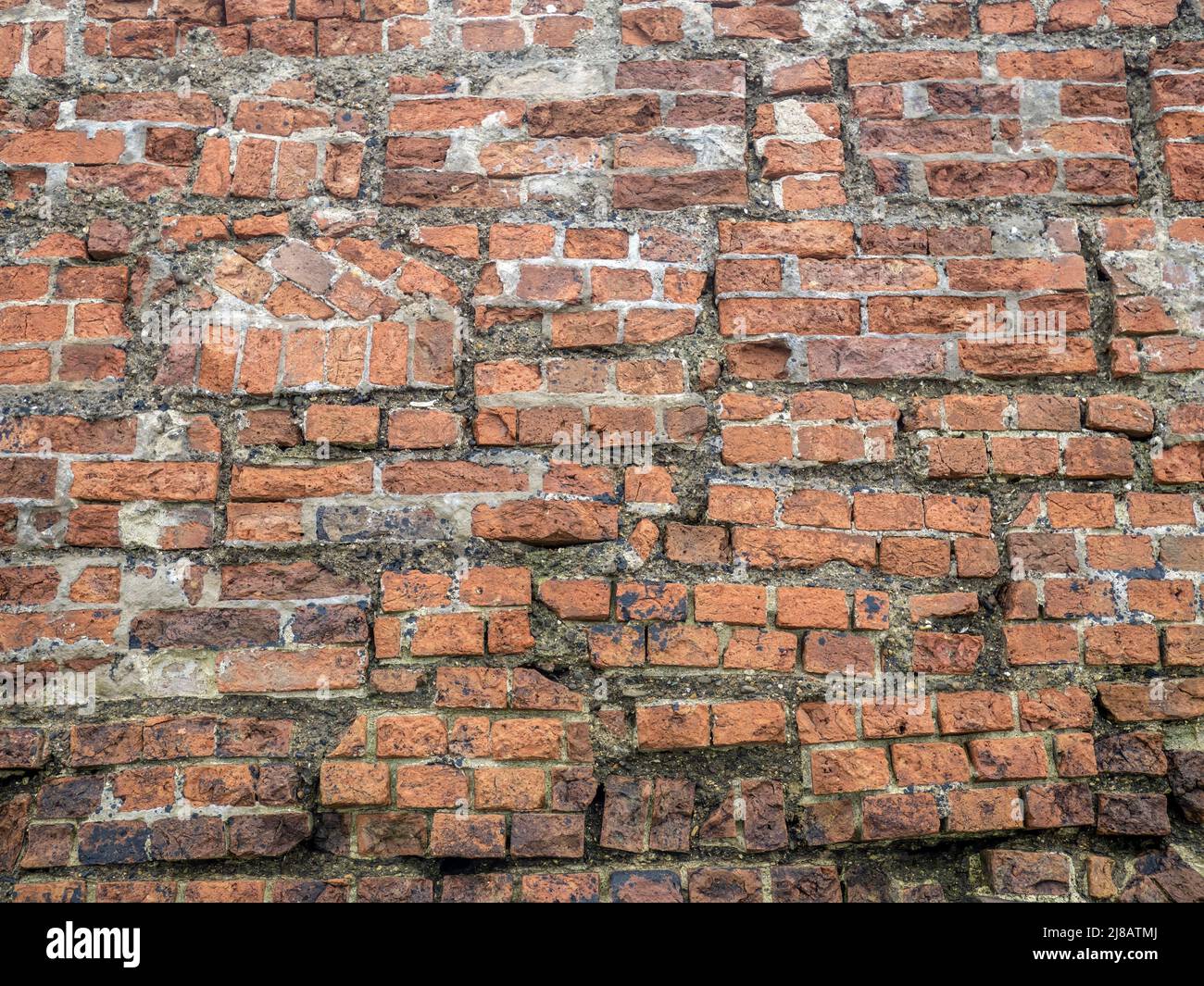Very old brick wall, rebuilt. Background. Stock Photo