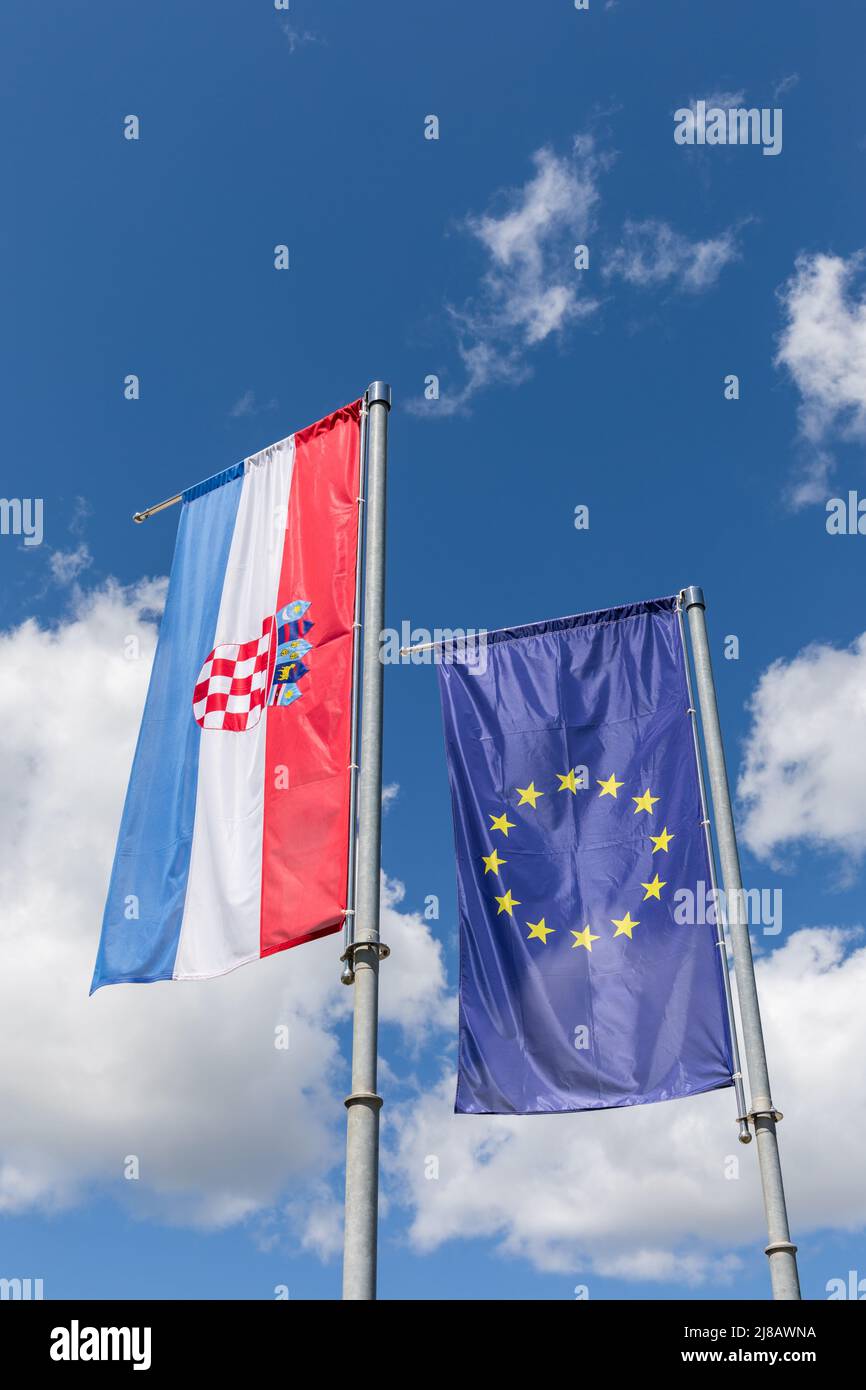 The flag of Europe and the flag of Croatia waiving in the wind Stock Photo