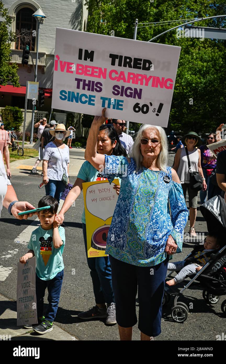 Photo of an older person holding an amusing protest sign during the Roe Bans off our Bodies March and  Rally organized by Planned Parenthood. Stock Photo