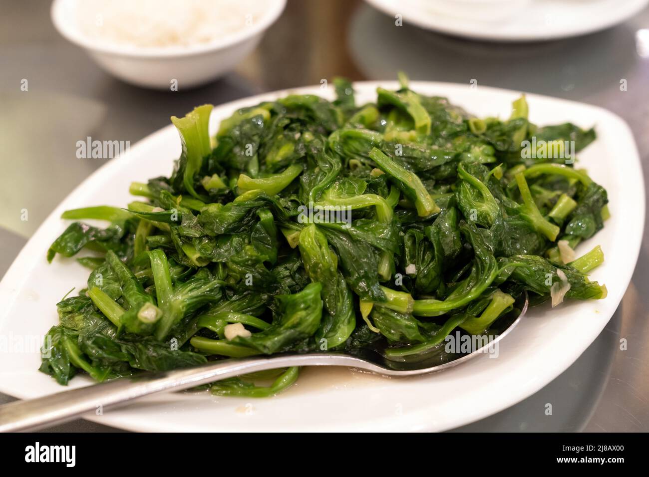 Simple and healthy stir fried oriental green vegetables. Stock Photo