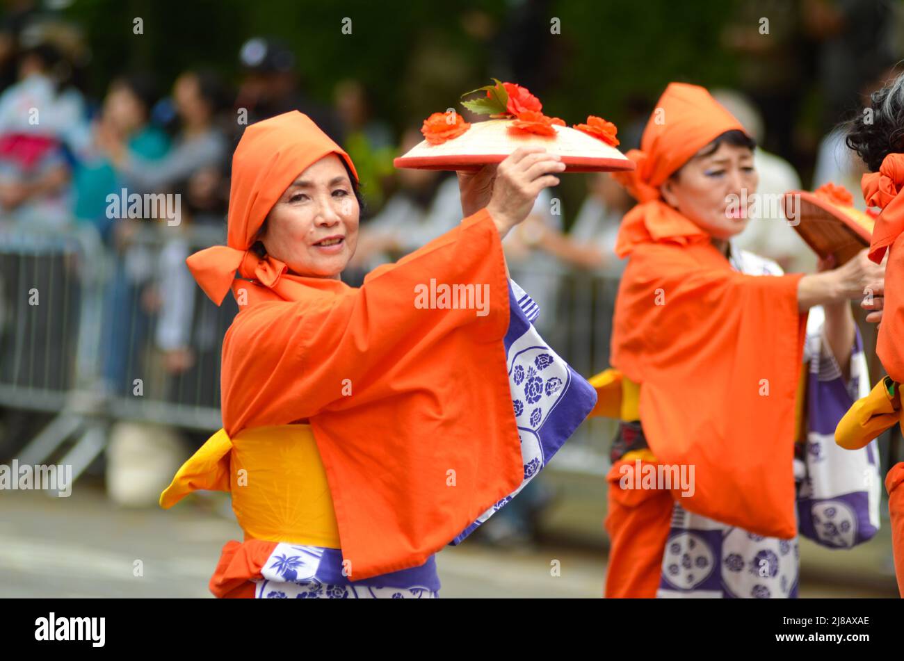 JapaneseAmericans wearing traditional Japanese clothing to march down
