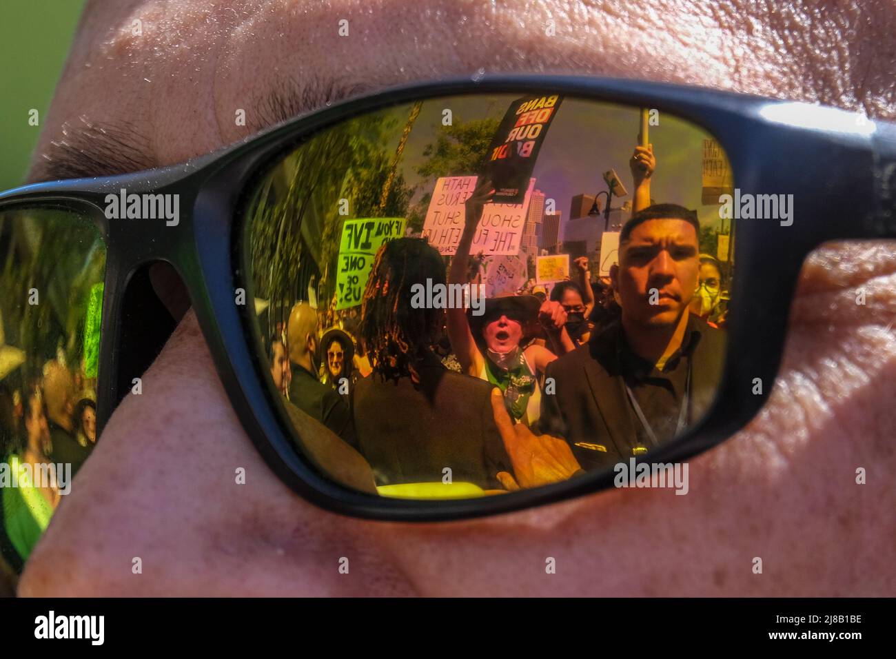 Los Angeles, California, USA. 14th May, 2022. Abortion-rights protesters is reflected at the glasses of an anti-abortion demonstrator in a ''Bans Off Our Bodies Abortion Rally'' on Saturday, May 14, 2022 in Los Angeles. (Credit Image: © Ringo Chiu/ZUMA Press Wire) Stock Photo
