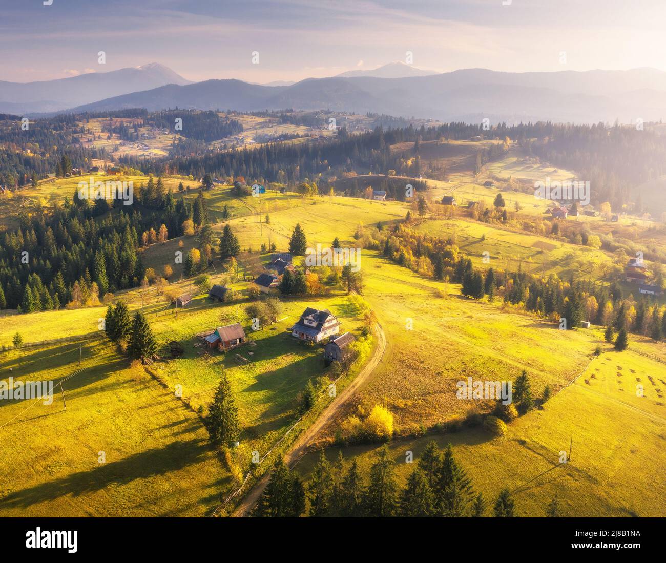 Aerial view of beautiful village in mountains at sunset Stock Photo