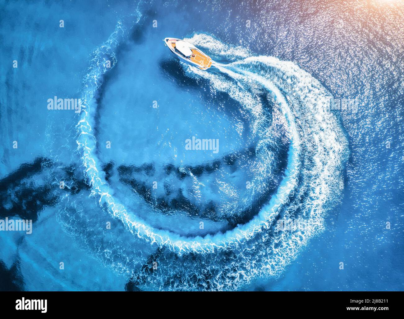 Aerial view of the speed boat in clear blue water at sunset Stock Photo ...