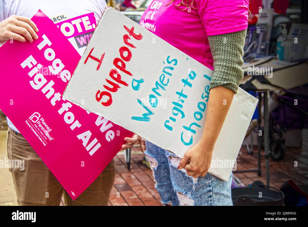 2021-10 02 Tulsa USA Young male and female protestors talking at reproduction rally both holding signs including Planned Parenthood Stock Photo