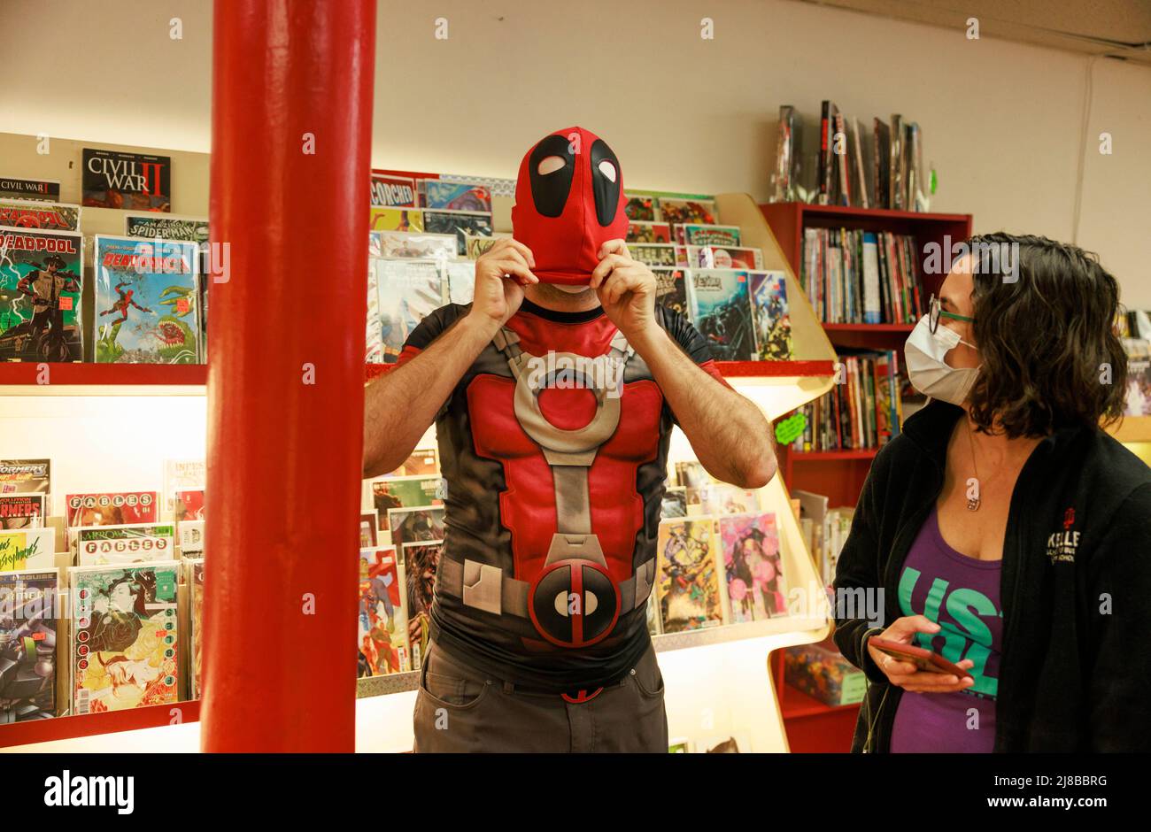 BLOOMINGTON, INDIANA, UNITED STATES - 2022/05/07: Comic books fans dressed as Elektra and Deadpool pose for photos during Free Comic Book Day 2002 at Vintage Phoenix Comic Books, on Saturday, May 7, 2022 in Bloomington, Ind. The last Free Comic Book day was delayed until August in 2021 and canceled entirely in 2020 due to the Covid-19 pandemic. (Photo by Jeremy Hogan/The Bloomingtonian) Stock Photo
