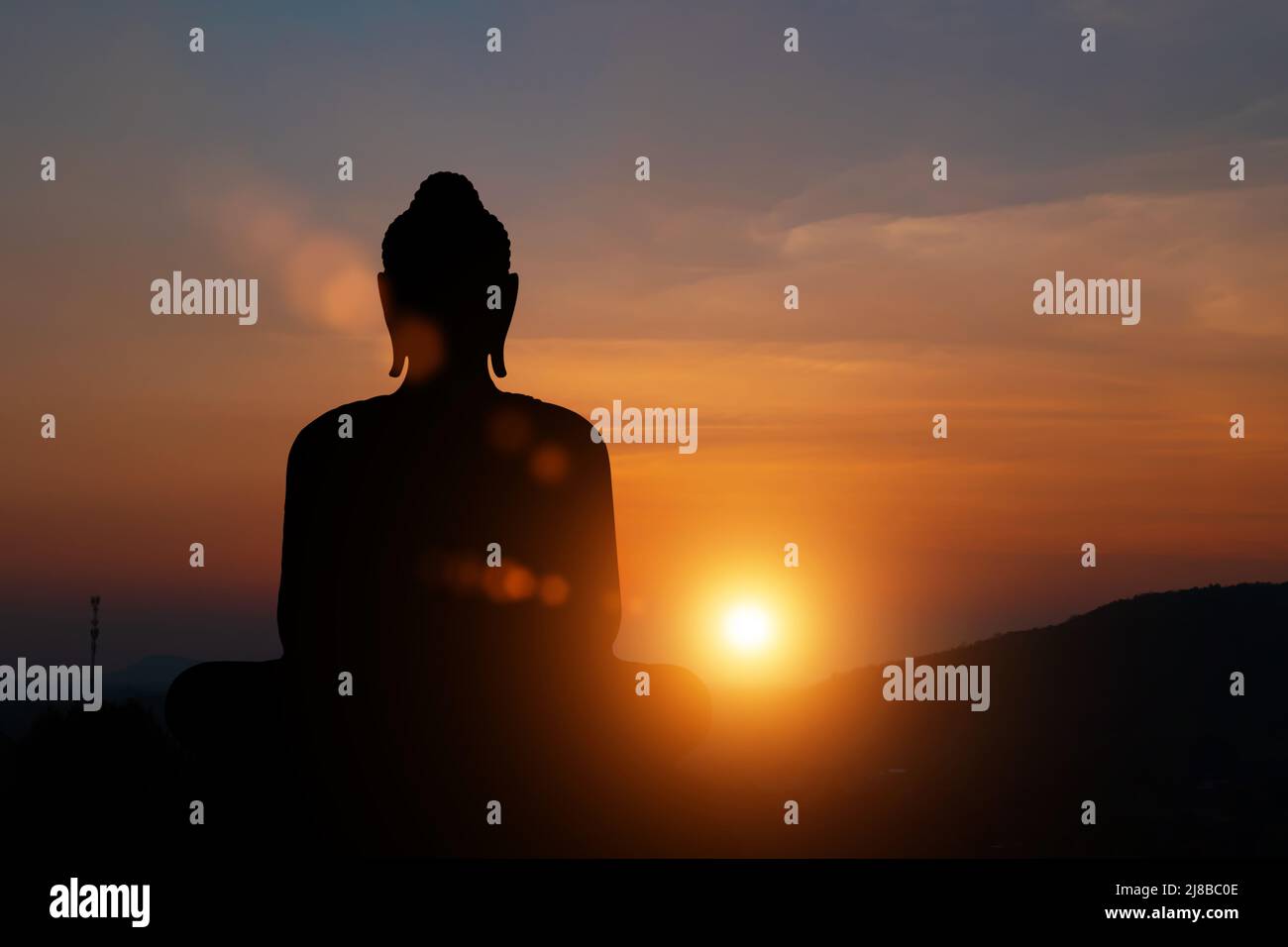Silhouette of buddha statue at sunset sky background. Buddhist holy