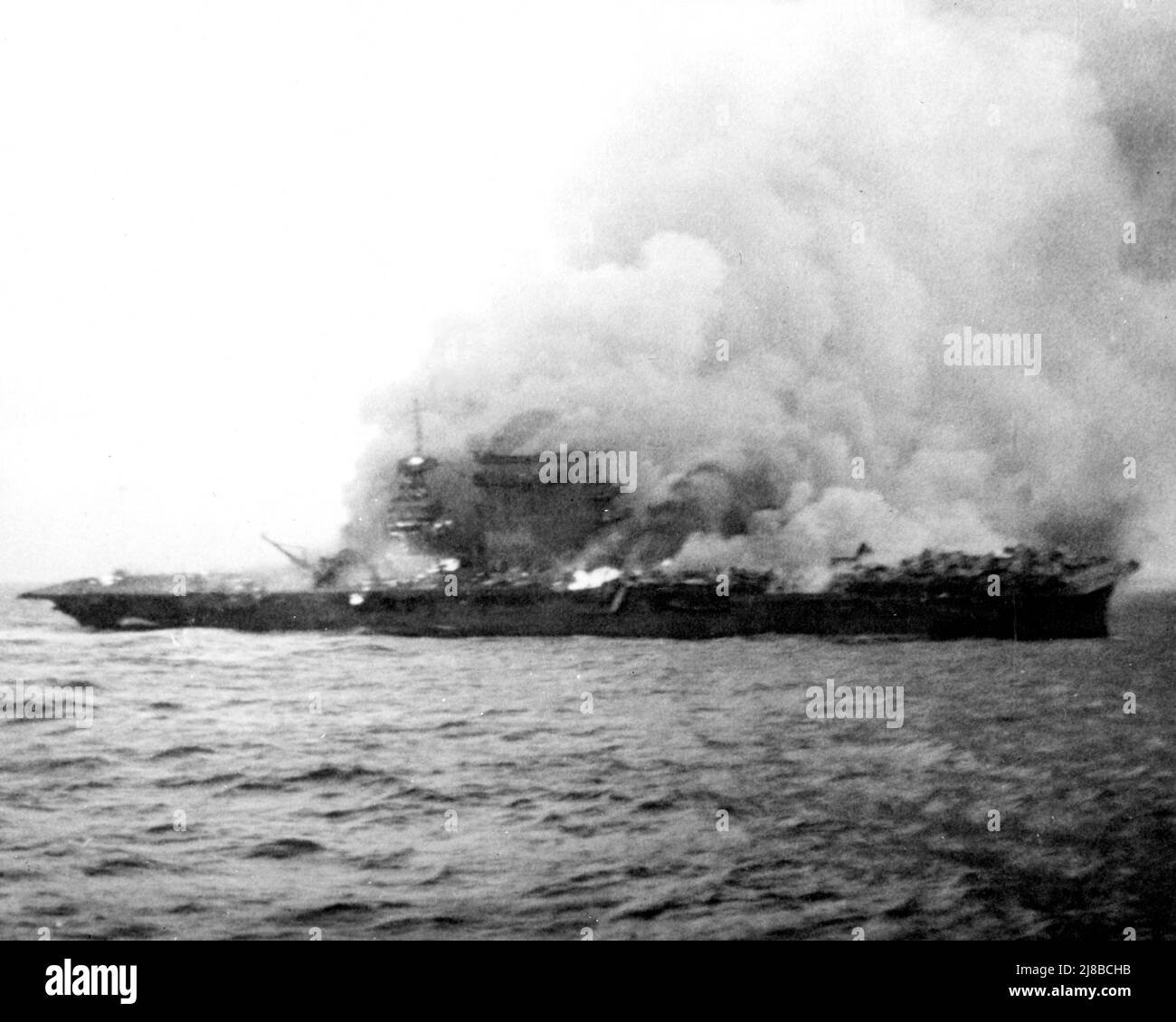 Lexington abandoned and on fire during the Battle of Coral Sea, World War II. Stock Photo