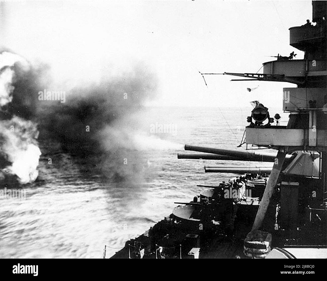 Battleship USS New York firing on Iwo Jima during World War II. Stock Photo