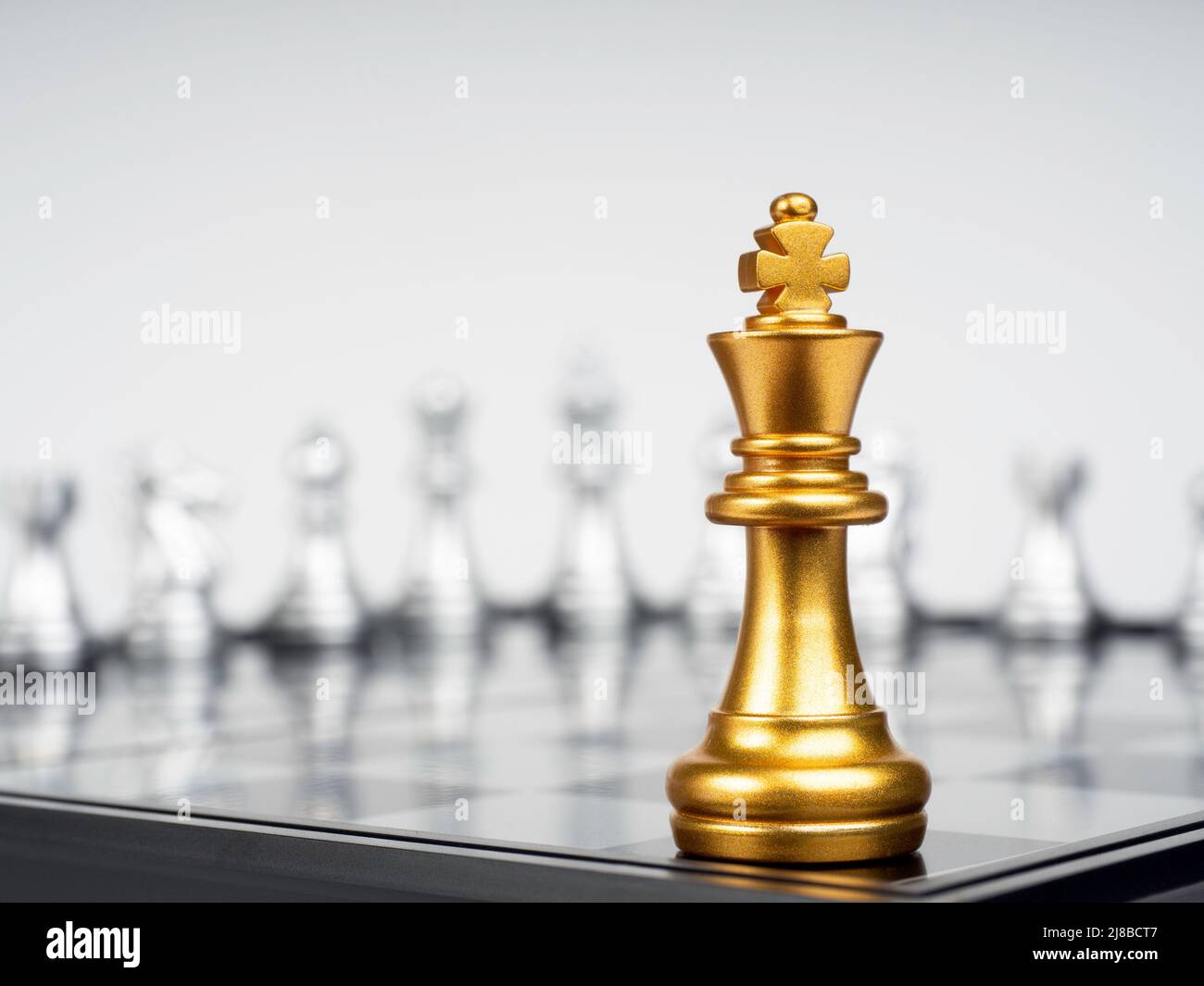 Golden Chess King In Front Of A Checkered Board Stock Photo