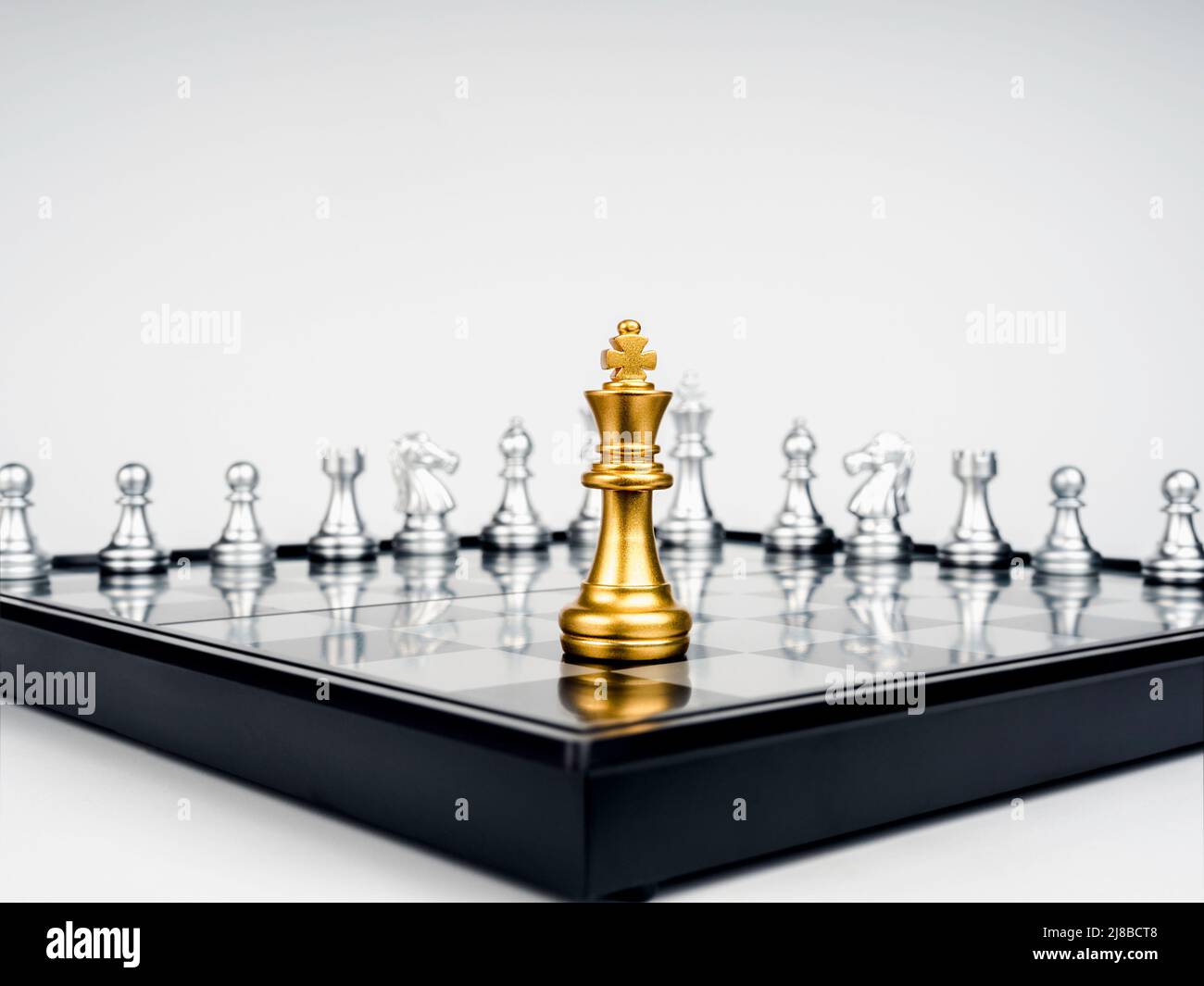 The Golden king chess piece standing on chessboard corner in front of