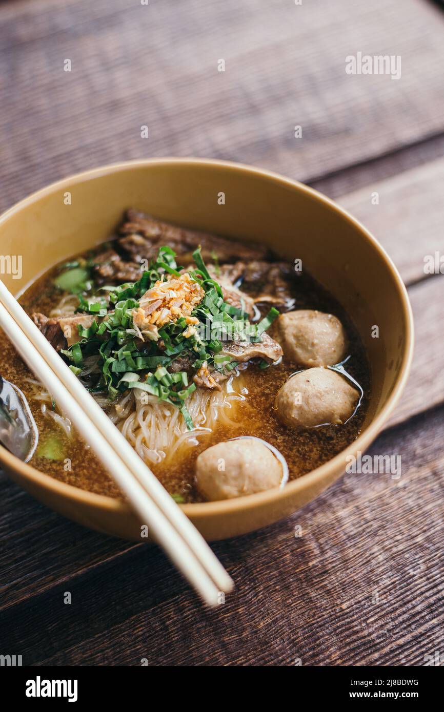 Beef noodle bowl on wooden table Stock Photo