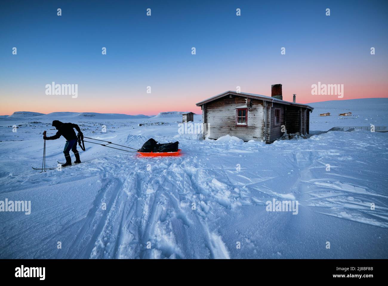Ski touring in Lapland, Saarijärvi open wilderness hut in the background. Enontekiö, Lapland, Finland Stock Photo