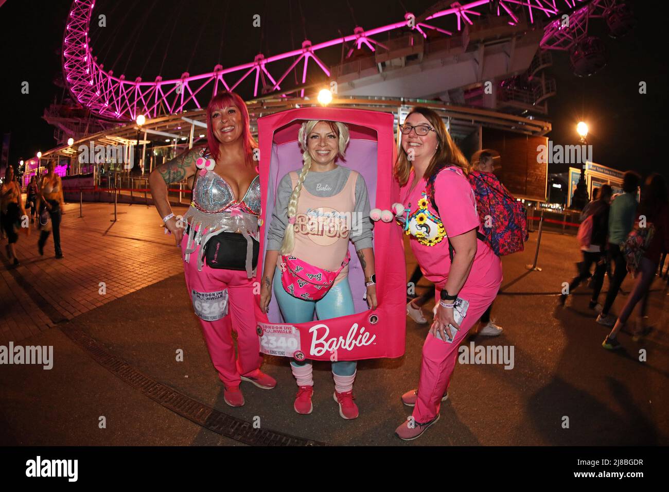 London, UK. 14th May 2022. London, UK. Participant dressed as her hero Barbie, complete with box at the Walk the Walk Moonwalk walking through London wearing decorated bras fundraising for breast cancer charities doing a marathon overnight. This year the theme is 'Your Heroes' and there were numerous rainbow themed costumes and bras in support of NHS heroes, also many superhero costumes and even blue and yellow Ukranian flag themed costumes in support of Ukrainian heroes. Credit: Paul Brown/Alamy Live News Stock Photo