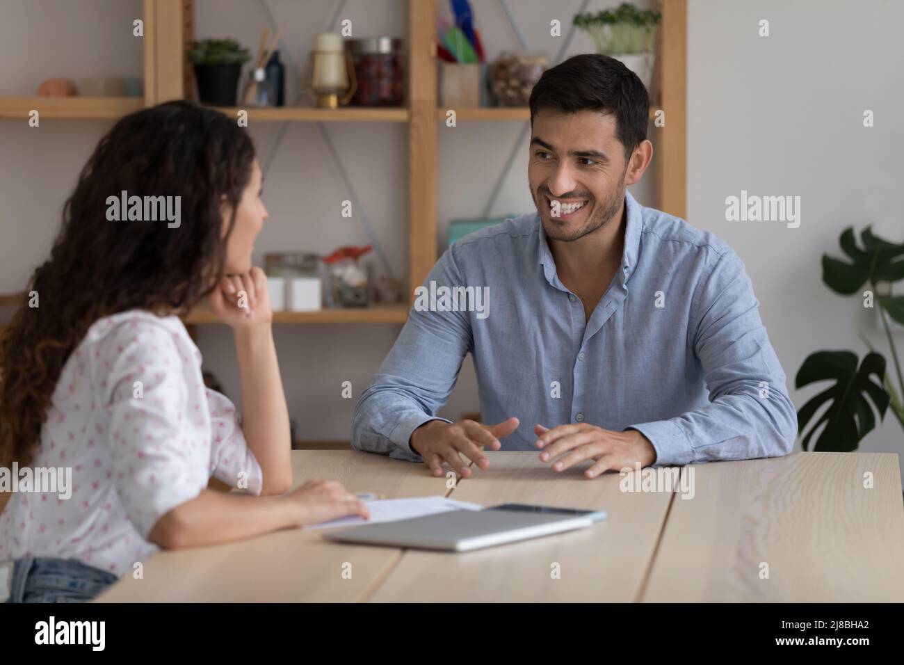 Happy confident mentor training intern, teaching student, smiling Stock Photo