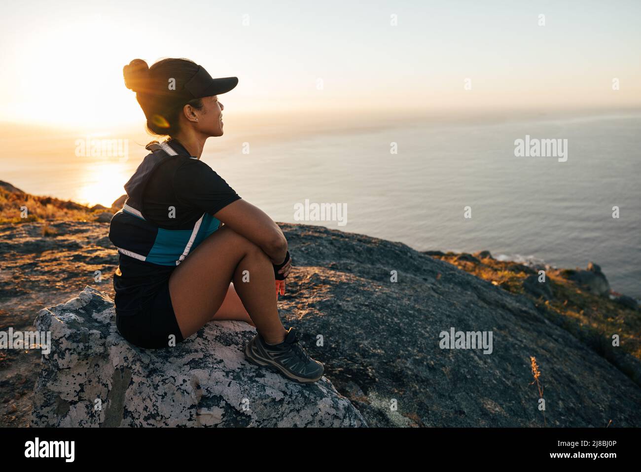 Female hiker sitting on rock hi-res stock photography and images - Alamy
