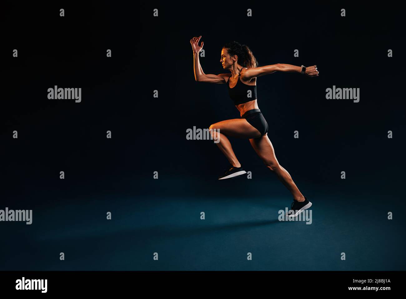 Buff Female Runner Muscular healthy woman running. Caucasian female runner in sportswear ...