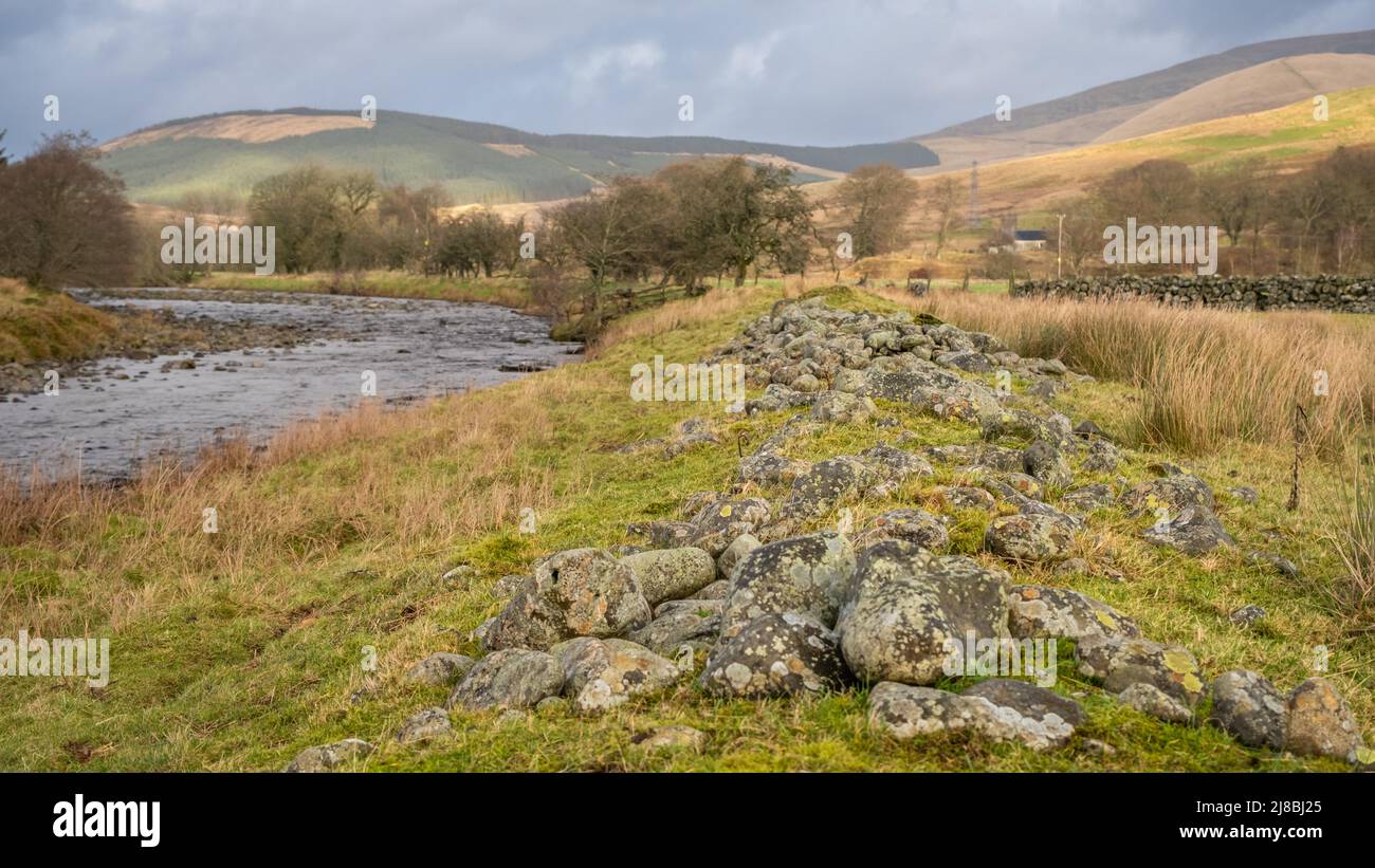 Close up of dredged river rocks offering flood bank protection for fields in Scotland Stock Photo