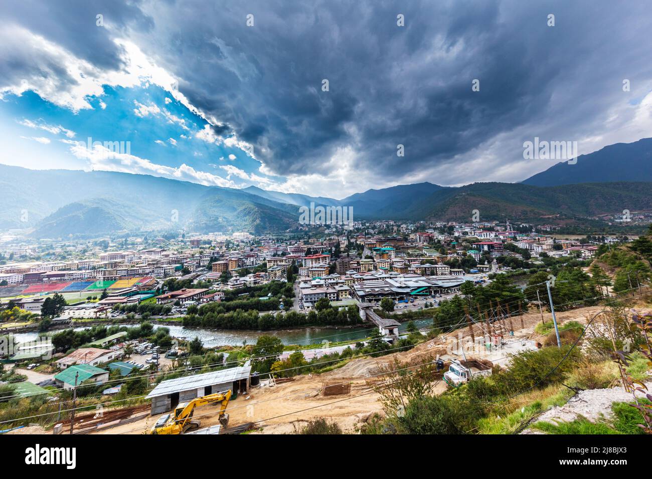 Thimphu, Bhutan - October 26, 2021: Aerial view cityscape of Bhutan capitol city. Top view with dramatic cloudy sky over the town. Largest city in Bhu Stock Photo