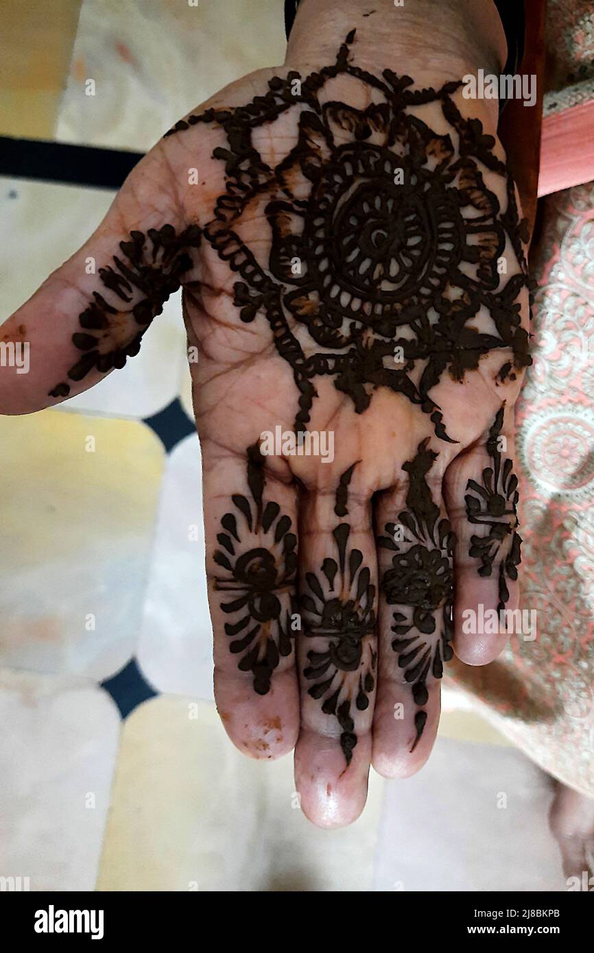 View of palm showing still wet and freshly drawn mehandi paste Stock Photo