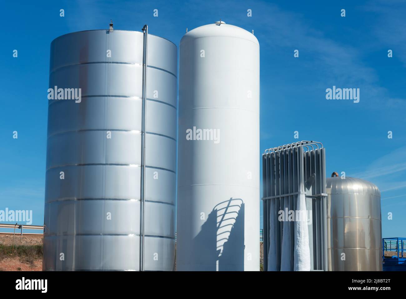 Several tanks for the storage of liquids, one of them for cryogenic gases. Stock Photo