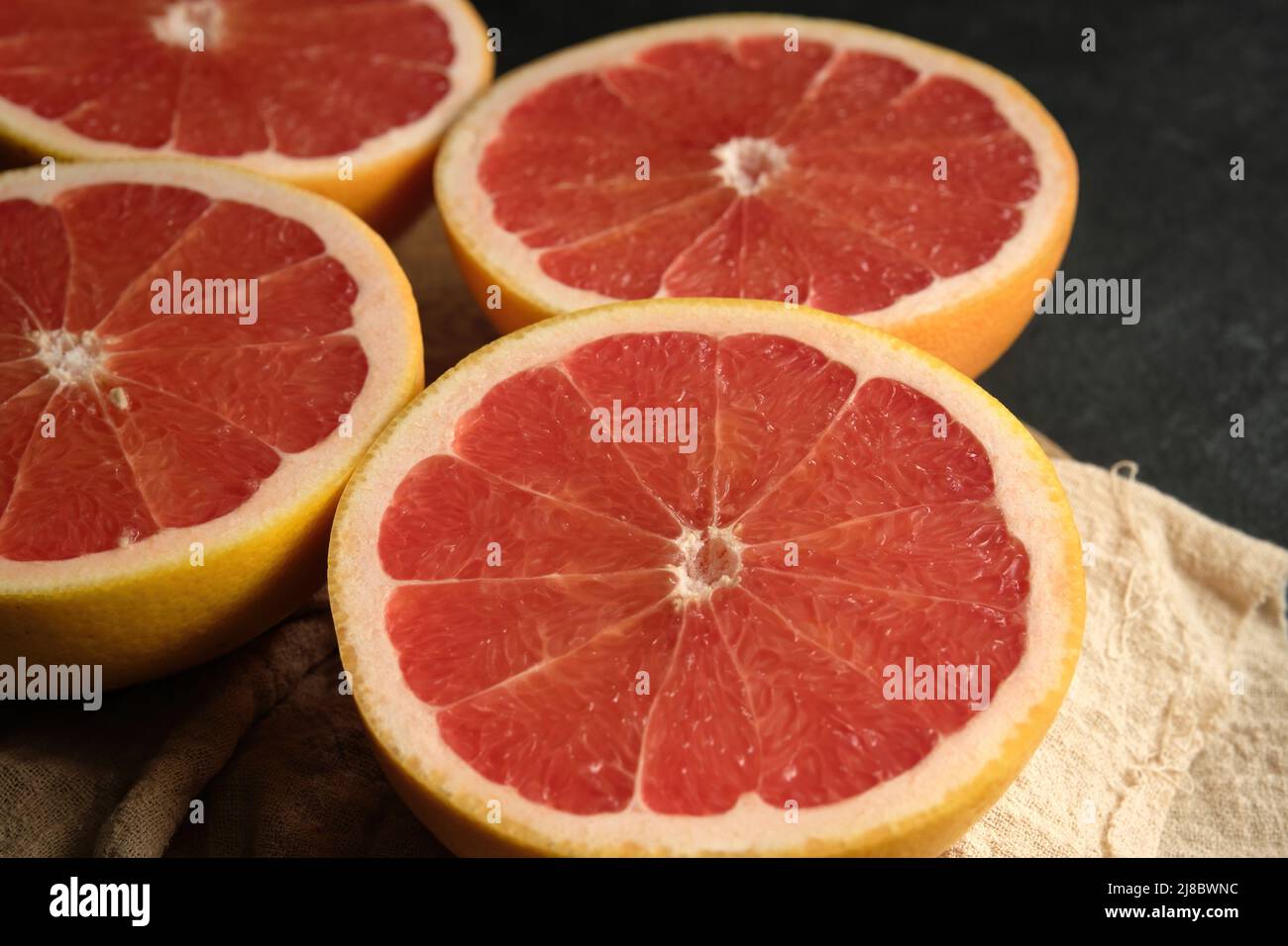 sliced ripe grapefruit on a light cloth Stock Photo