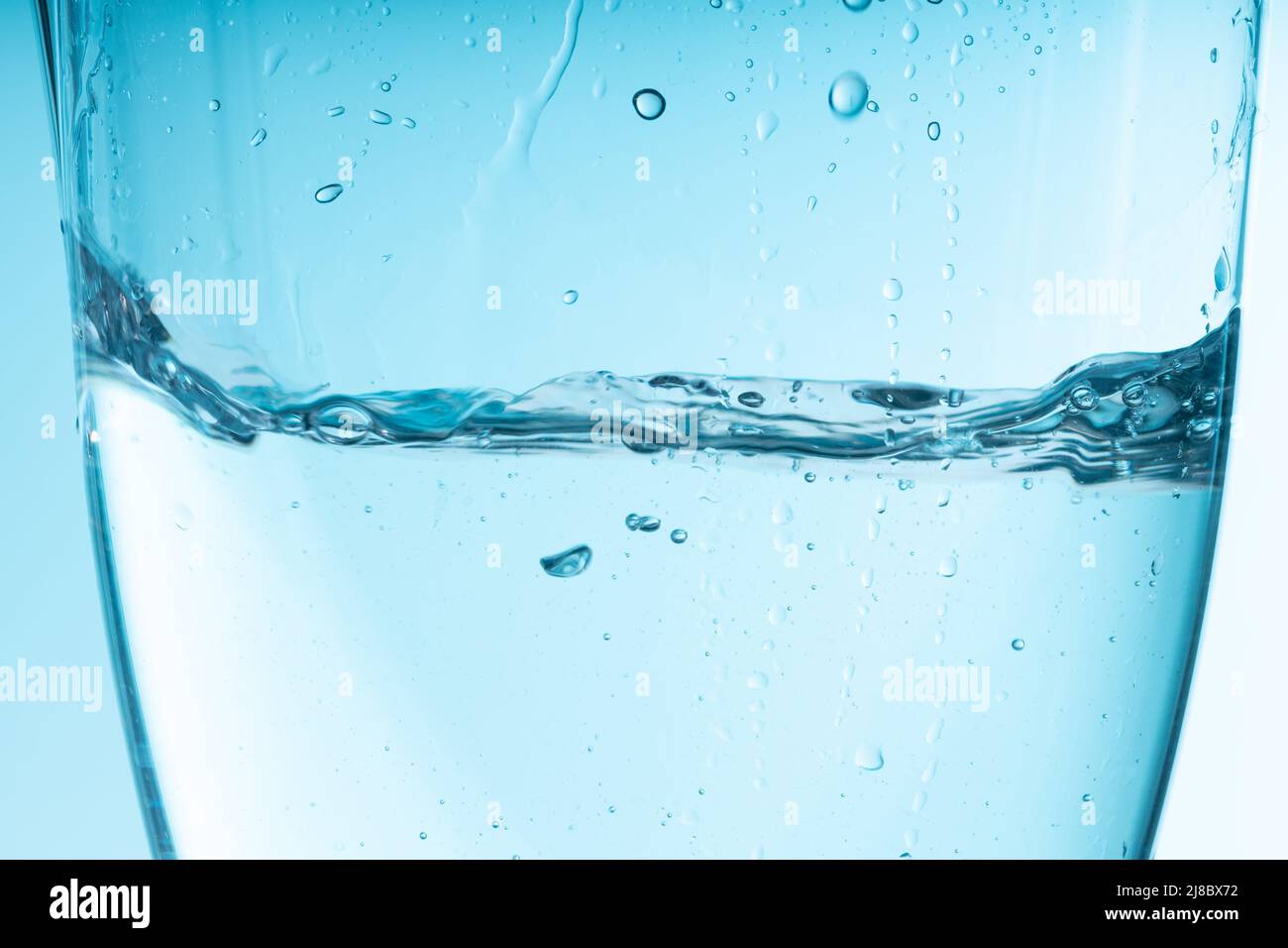 https://c8.alamy.com/comp/2J8BX72/blue-splash-of-water-in-a-glass-vessel-clean-clear-water-high-quality-photo-2J8BX72.jpg