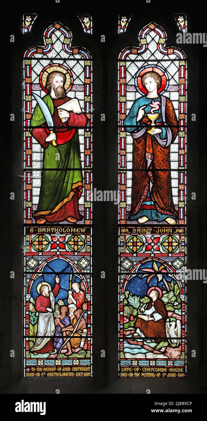 A stained glass window by Frederick Preedy depicting Ss Bartholomew and John, St John in Patmos and Bartholomew preaching, Fladbury Church, Worcesters Stock Photo