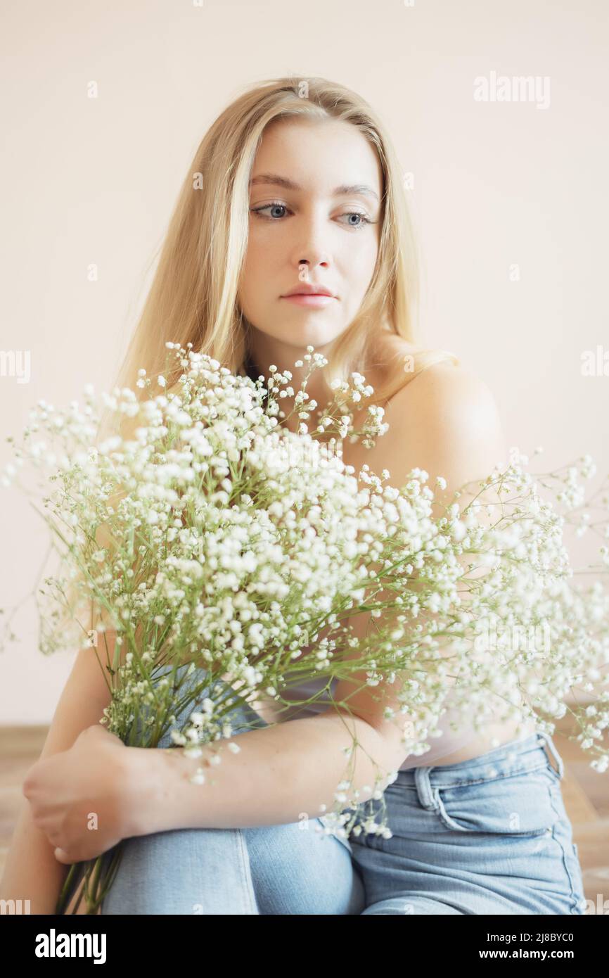 Young woman with bouquet of small flowers. Stock Photo