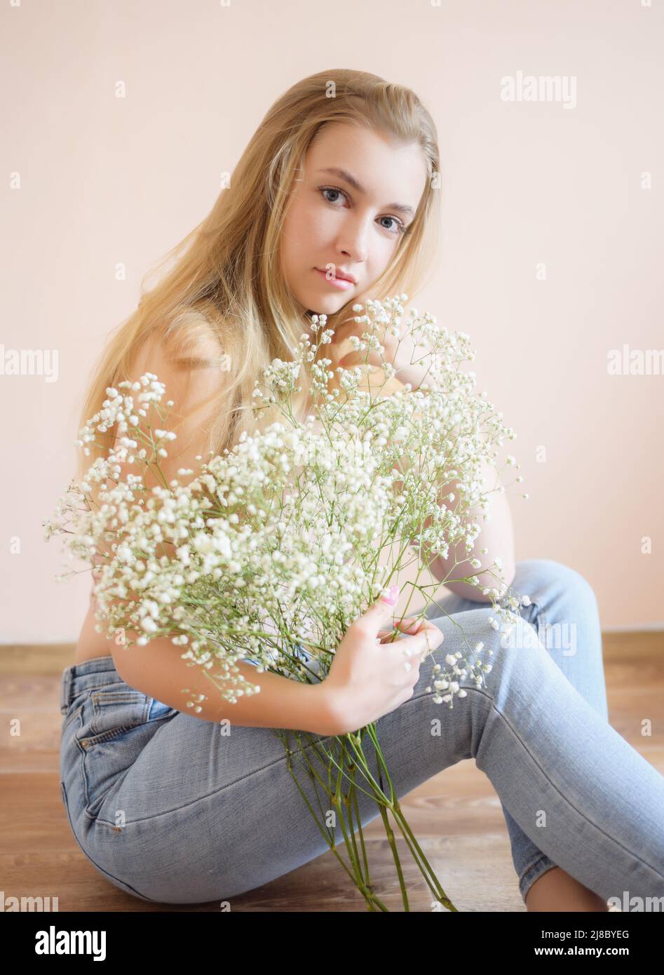 Young woman with bouquet of small flowers. Stock Photo