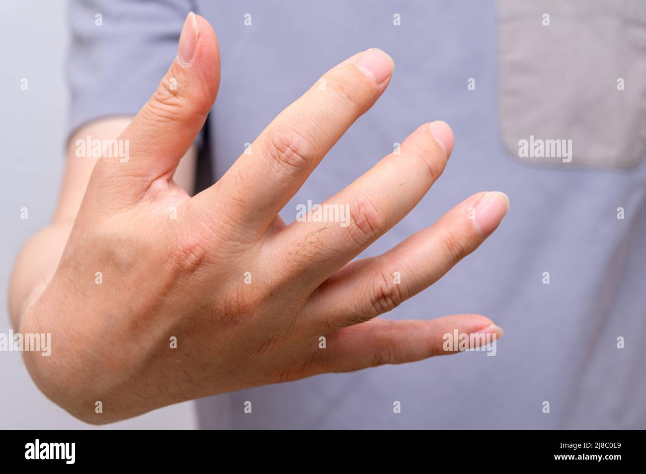Hands of men suffering from finger joint pain. Causes of rheumatoid arthritis, gout. Health care and medical concept. Stock Photo