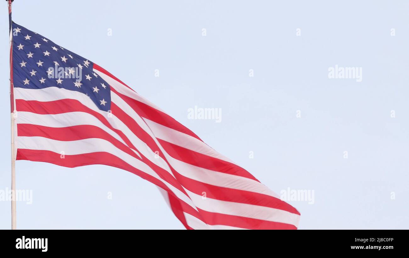 American flag waving in wind, USA. National symbol waves in breeze on
