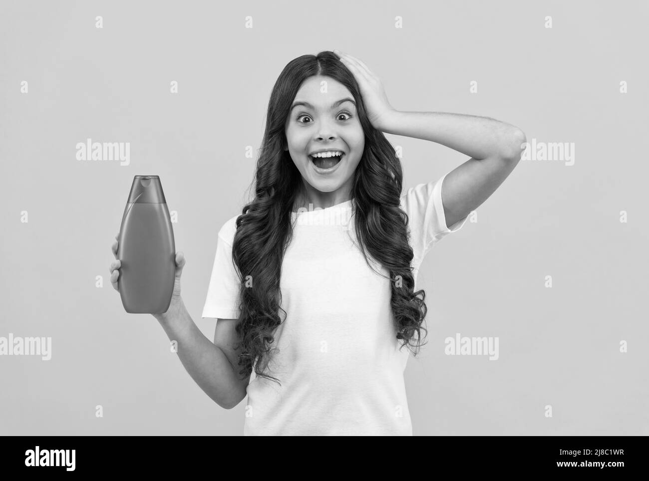 amazed kid with long hair hold shampoo bottle, hair Stock Photo Alamy