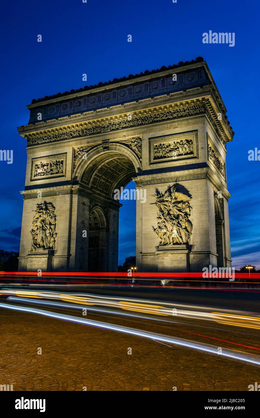 The Arch of Triumph with traffic traces of light during a dramatic sunset. Photo taken on 22nd of April 2022 in Paris, France. Stock Photo