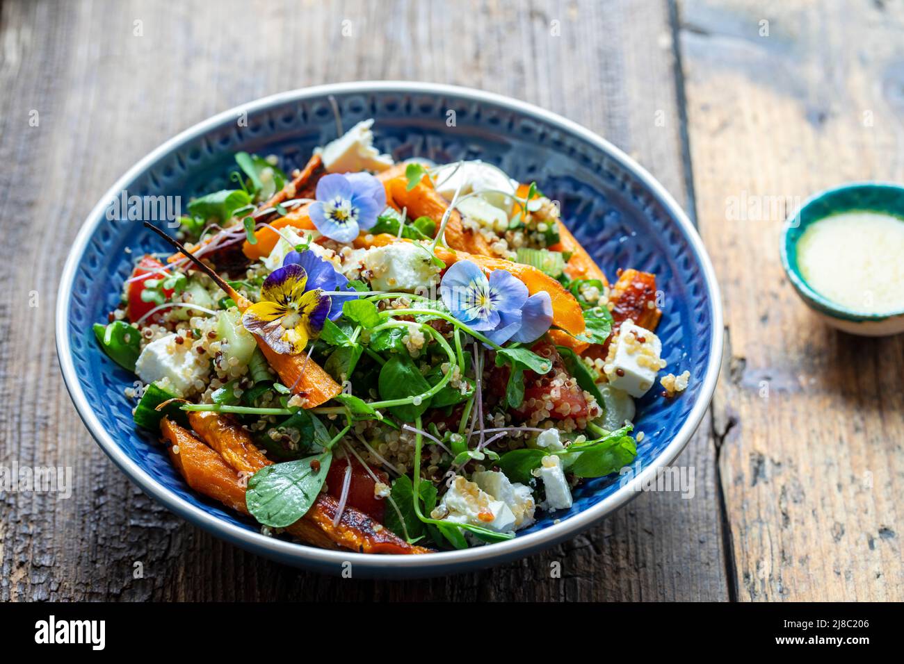 Quinoa salad with roast carrots and vegan cheese Stock Photo