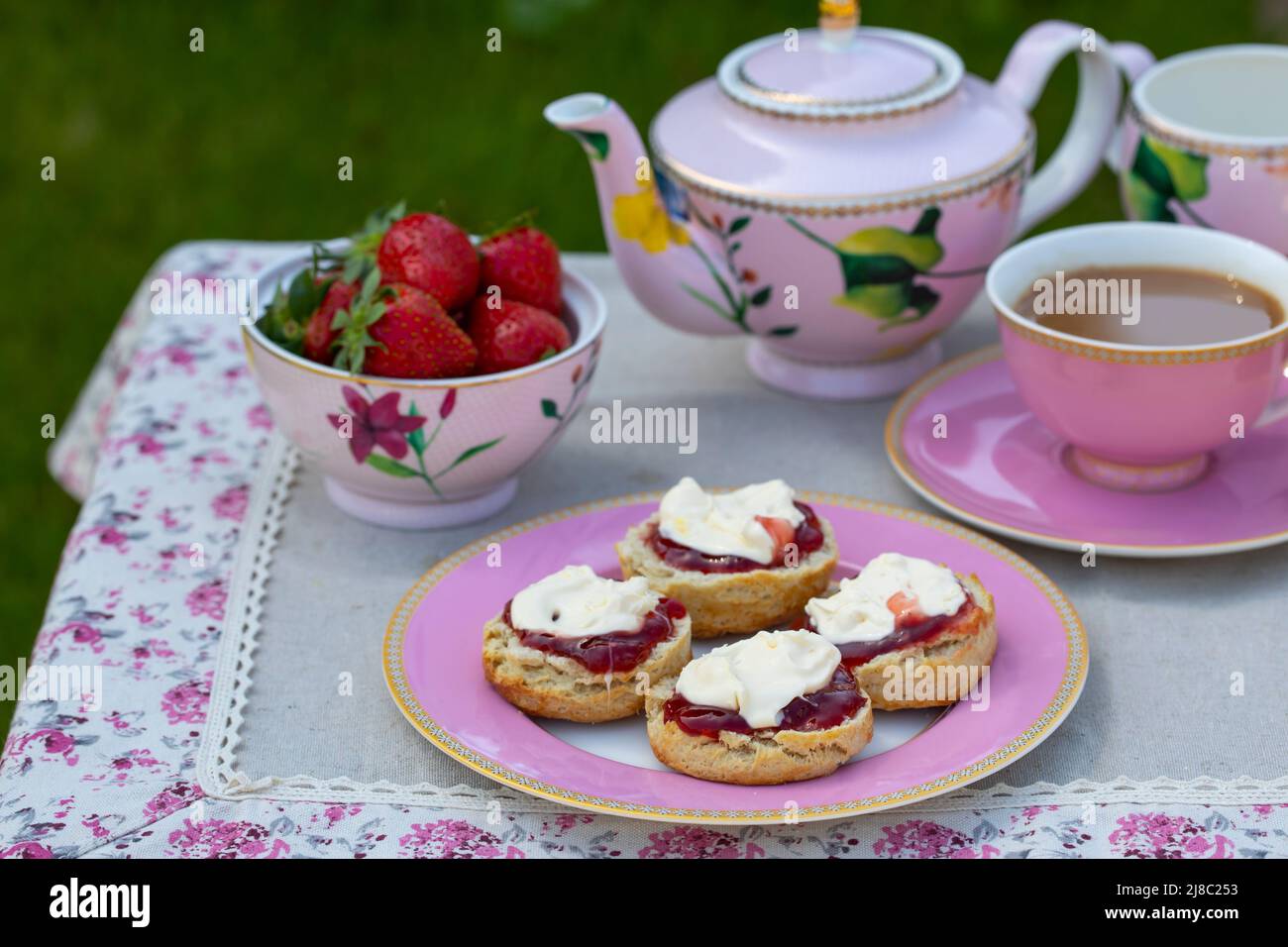 Freshly baked scones with tea served in the garden Stock Photo