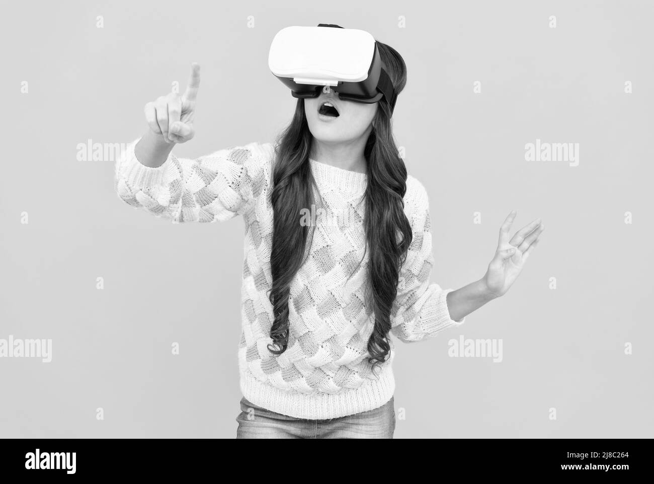 amazed teen girl wear vr glasses using technology for education in virtual reality, virtual world. Stock Photo