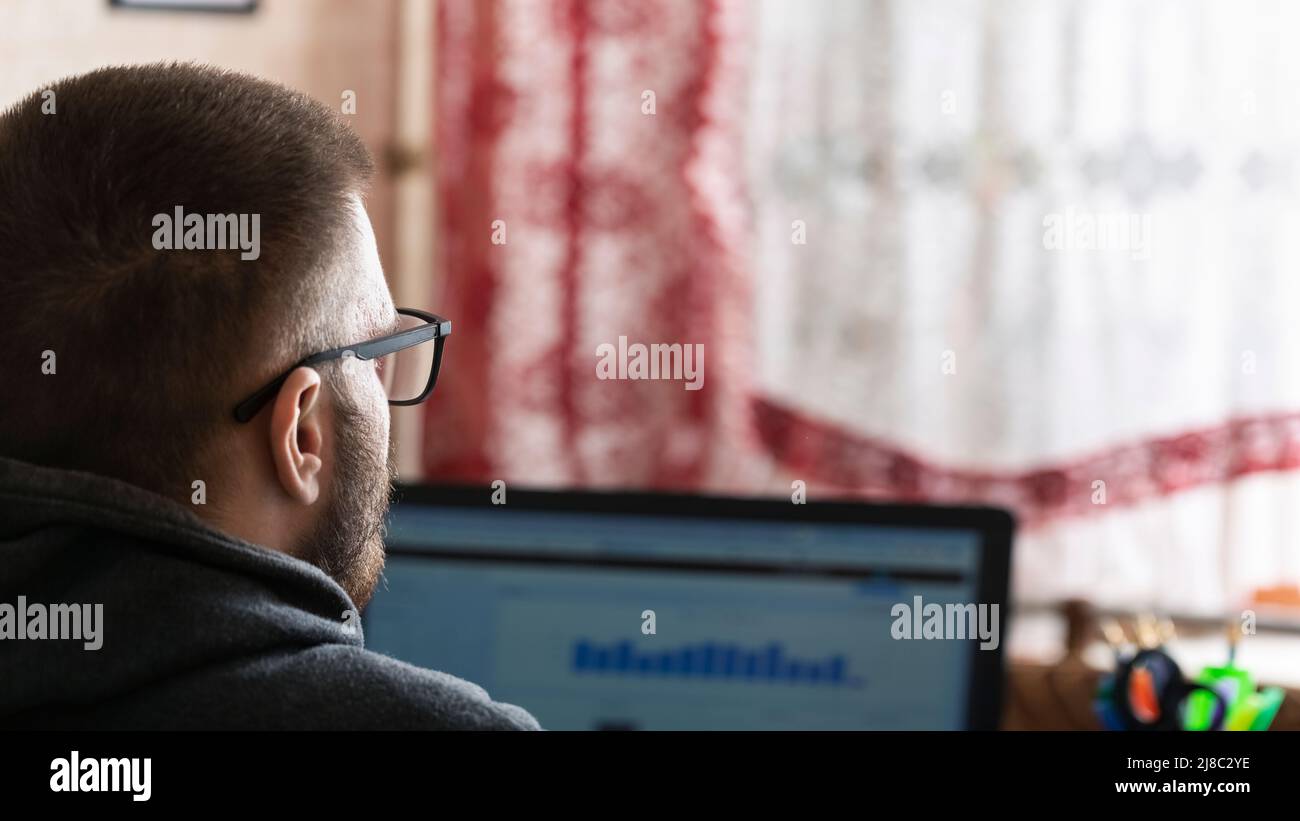 Young freelancer working at a computer at home, work remote from the office, home office Stock Photo