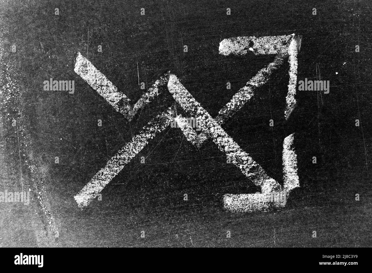 White color chalk hand drawing in up and down arrow shape on black ...