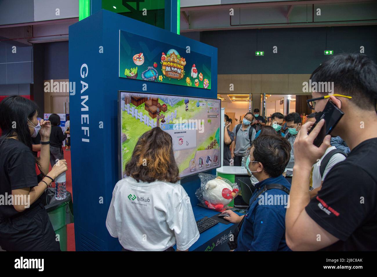 Visitors queue up to try the Play to Earn crypto game 