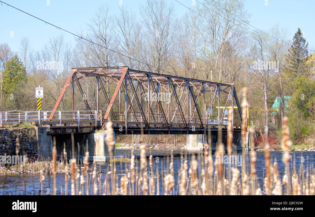 Andrewsville railway truss bridge built in 1900 crossing the Rideau Canal in spring in Andrewsville, Ontario, Canada Stock Photo