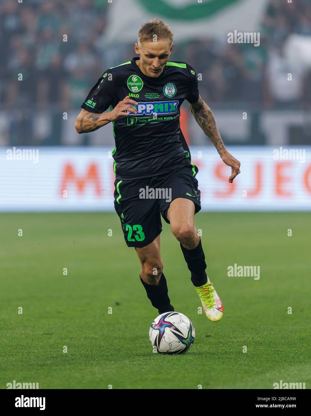 BUDAPEST, HUNGARY - MAY 11: Kristoffer Zachariassen of Ferencvarosi TC runs  with the ball during the Hungarian Cup Final match between Ferencvarosi TC  and Paksi FC at Puskas Arena on May 11