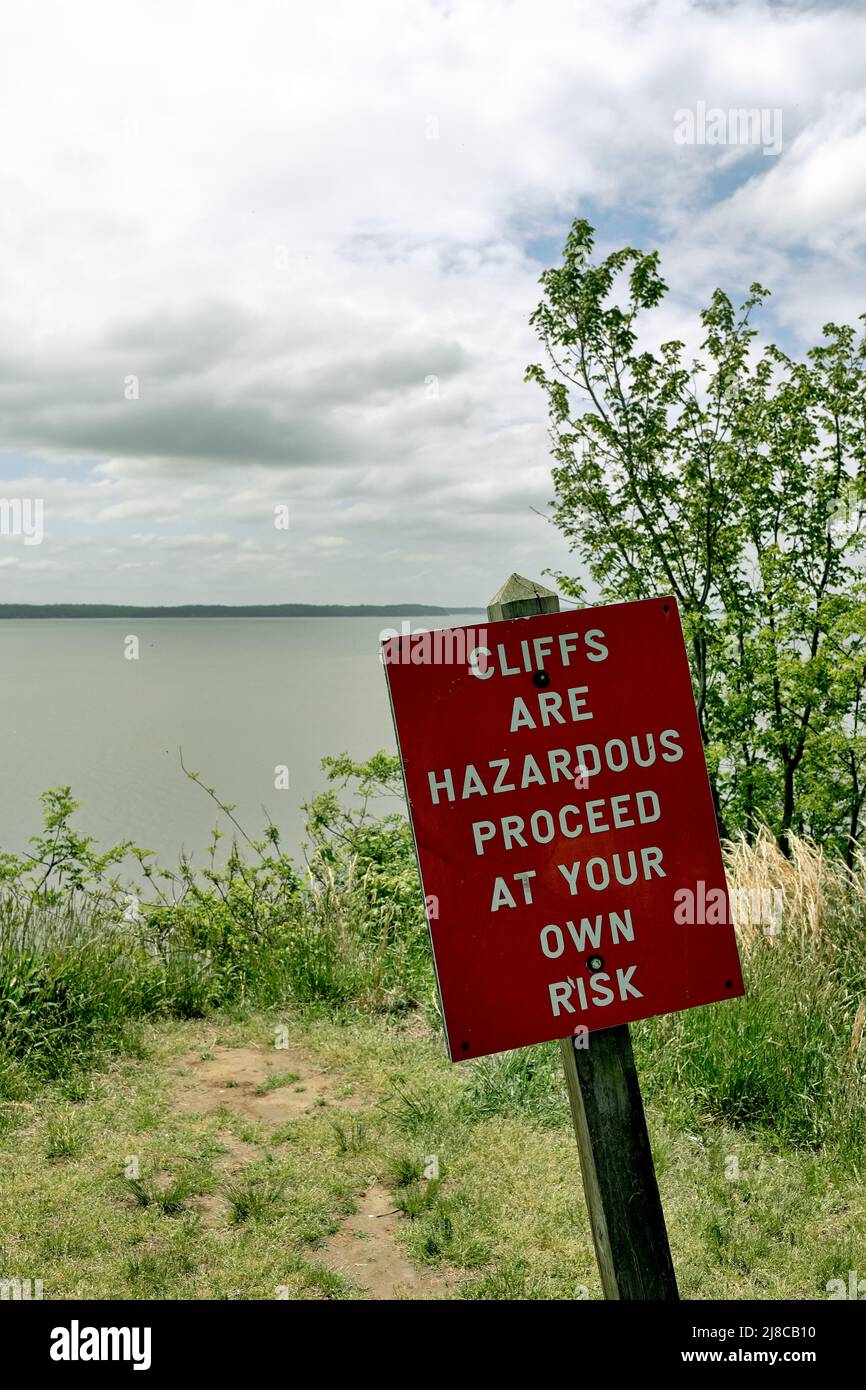 A sign warns of danger along the bluff near Turkey Point Lighthouse, the third highest lighthouse off the Chesapeake Bay. Stock Photo