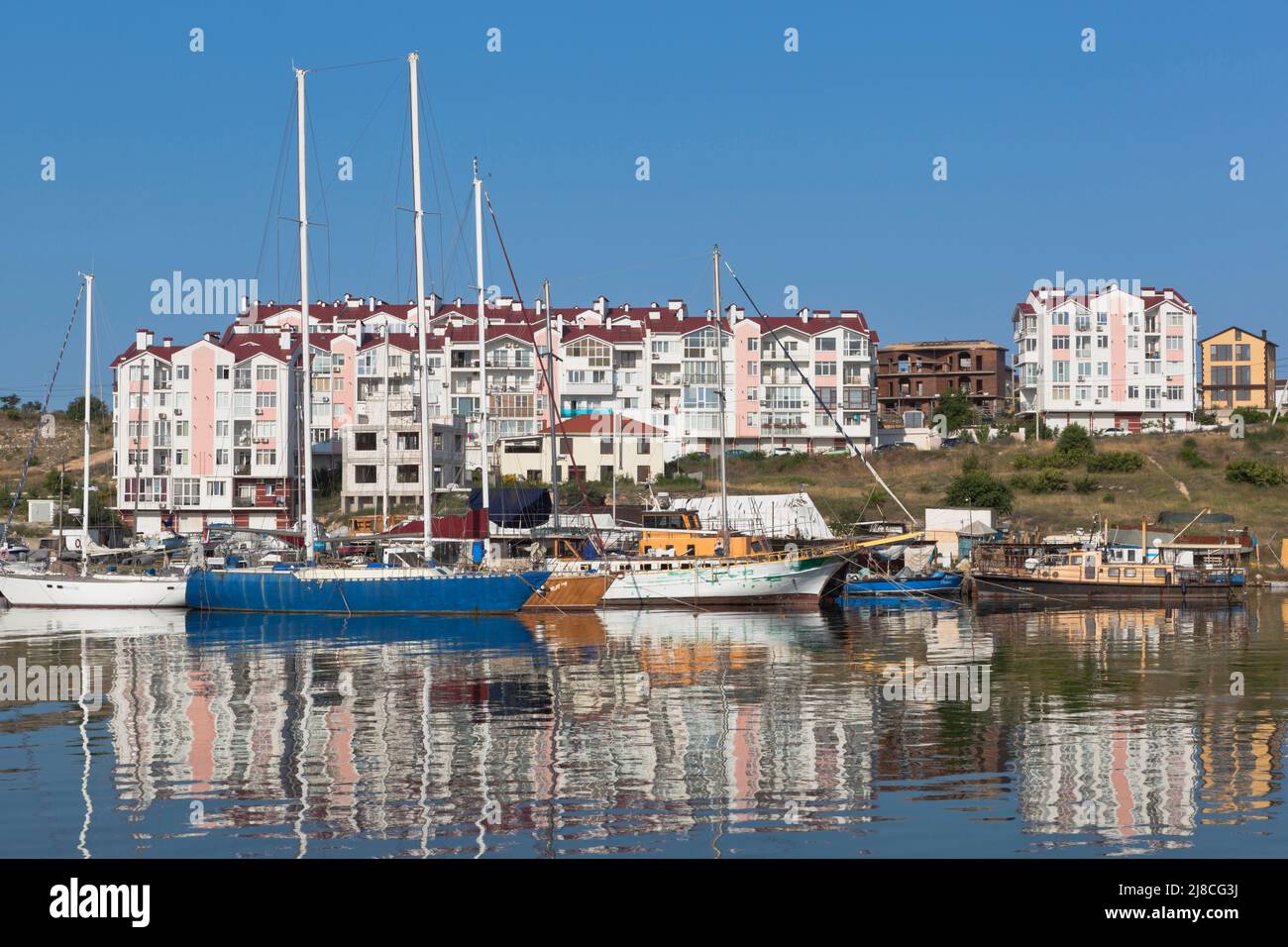 Sevastopol, Crimea, Russia - July 28, 2021: Sailing yachts at the pier in the Cossack Bay of the city of Sevastopol, Crimea Stock Photo