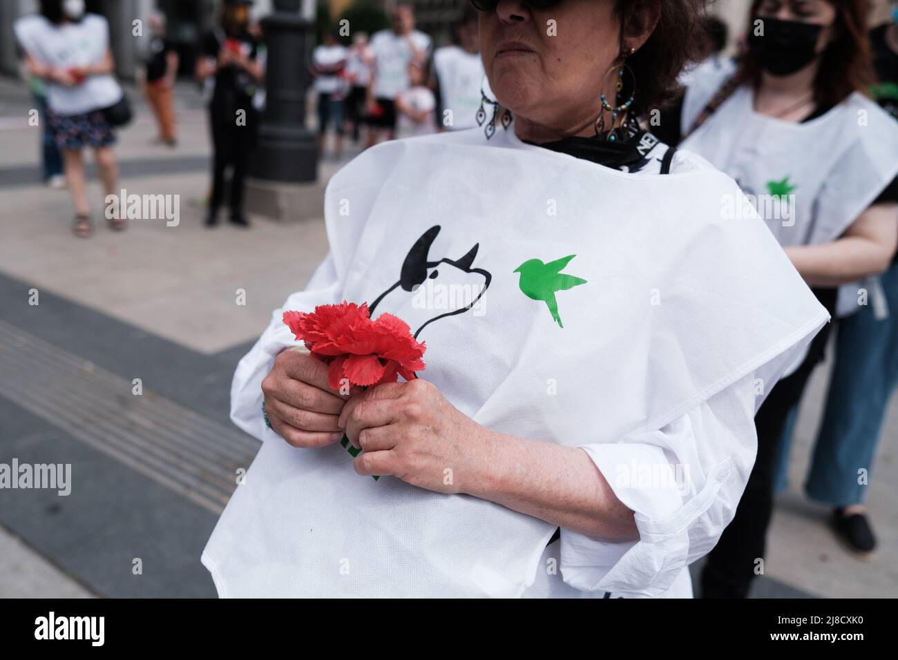 A protester holds a carnation during the anti-bullfighting rally to demand the prohibition of bullfighting at the San Isidro festivities in Madrid. (Photo by Atilano Garcia / SOPA Images/Sipa USA) Stock Photo