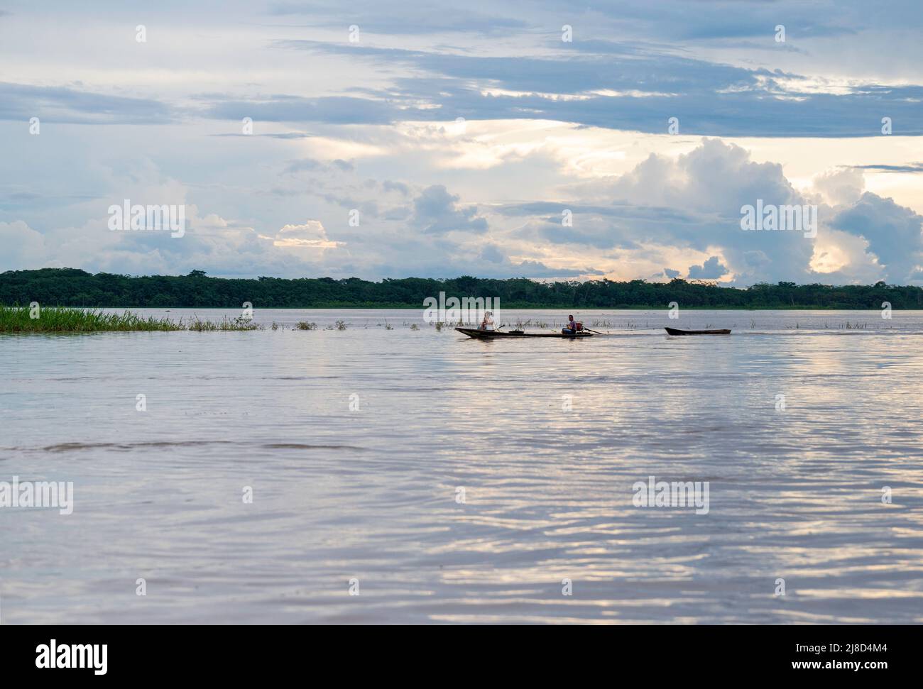 Local people returning from fishing at dusk on the Peruvian Amazon Stock Photo