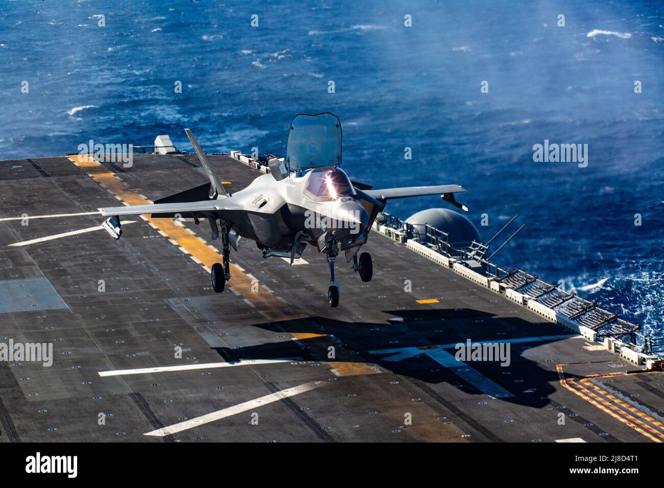 A U.S. Marine Corps F-35B Lightning II fighter aircraft, attached to the Knightriders of Marine Medium Tiltrotor Squadron 164, performs a vertical landing on the flight deck of the Wasp-class amphibious assault ship USS Makin Island, November 19, 2020 operating on the Pacific Ocean. Stock Photo