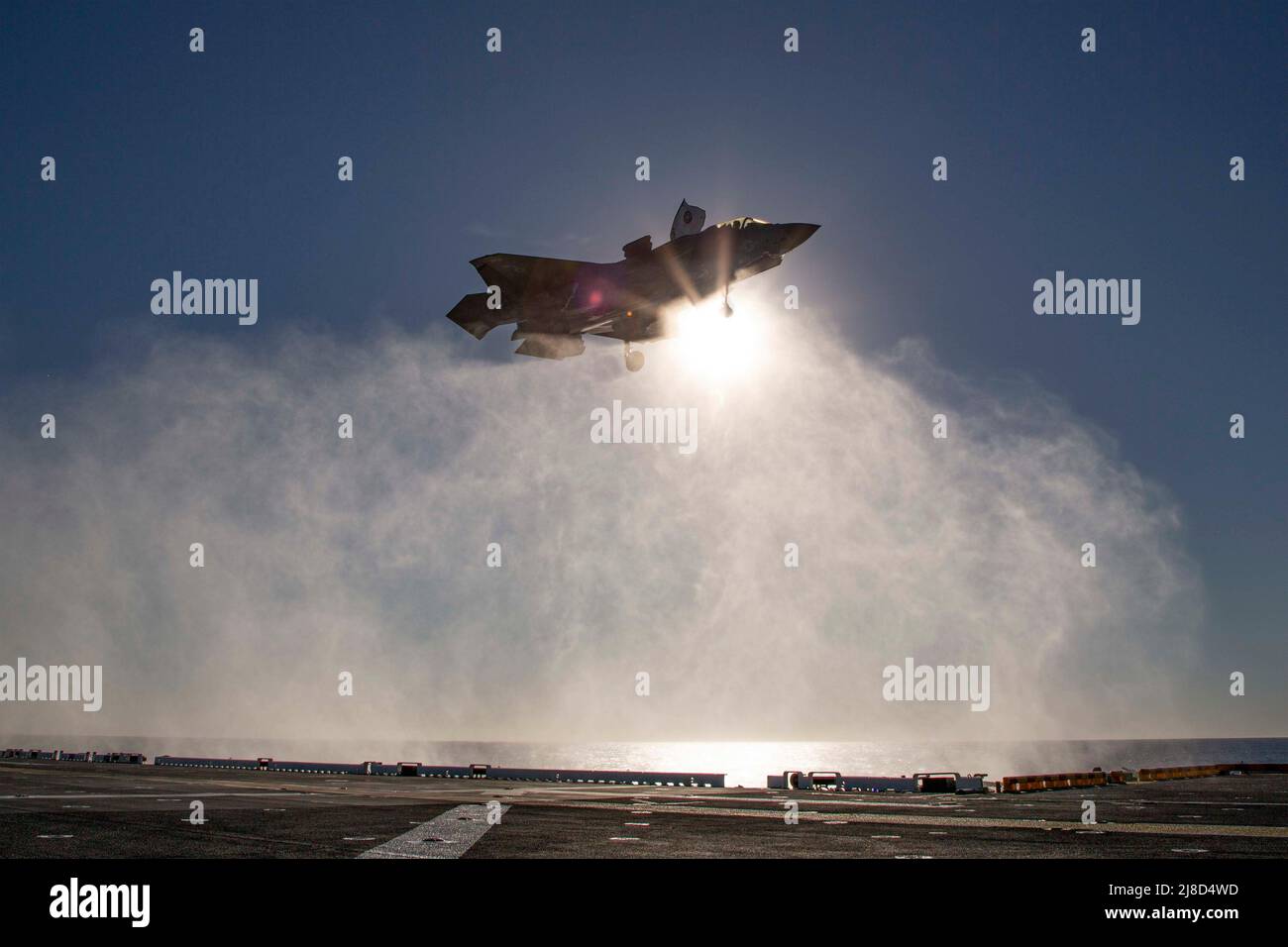 A U.S. Marine Corps F-35B Lightning II fighter aircraft, attached to the Flying Lethernecks of Marine Fighter Attack Squadron 122, performs a vertical landing on the flight deck of the Wasp-class amphibious assault ship USS Makin Island, February 6, 2022 operating on the Pacific Ocean. Stock Photo