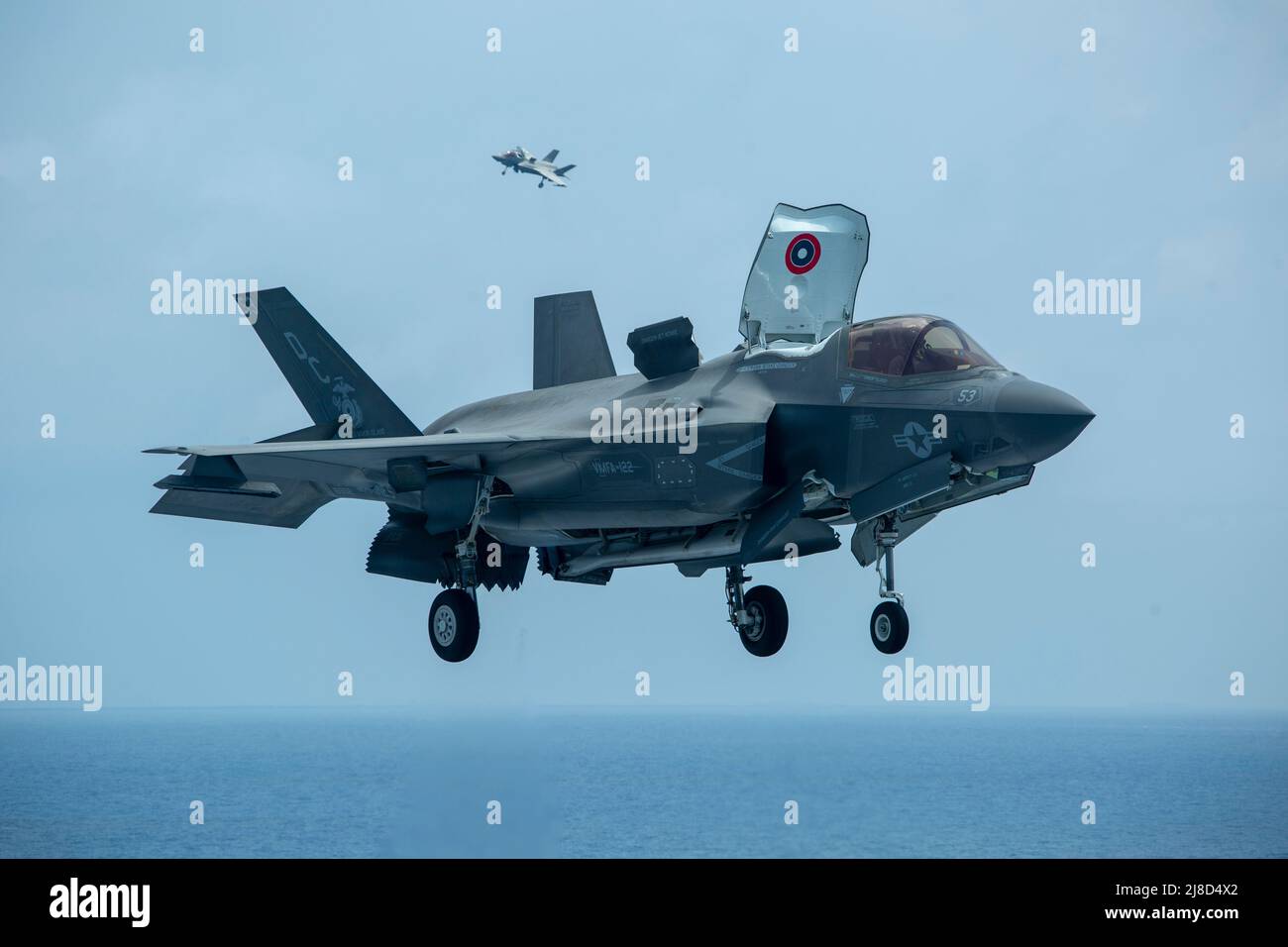 U.S. Marine Corps F-35B Lightning II fighter aircraft, attached to the Knightriders of Marine Medium Tiltrotor Squadron 164, approach for a vertical landing on the flight deck of the Wasp-class amphibious assault ship USS Makin Island, April 8, 2021 operating on the South China Sea. Stock Photo